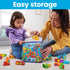 Adult and toddler putting colorful lettered Mega Bloks into a blue zippered storage bag, highlighting easy cleanup and parent-child interaction.