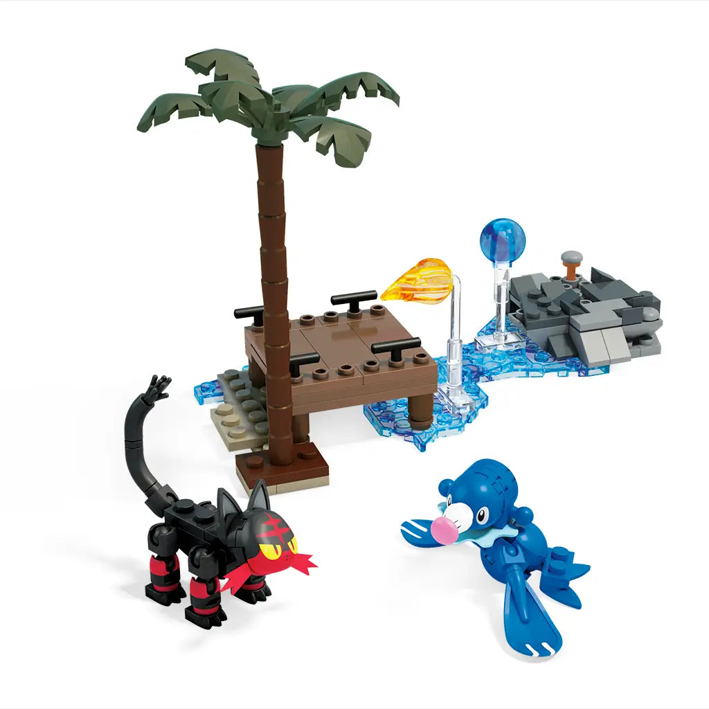 Buildable Mega Construx Pokémon Popplio and Litten figures displayed with a palm tree, dock, and rocky base surrounded by blue water elements for an action-themed beach battle scene.