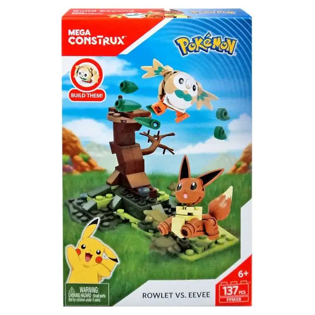Mega Construx Pokémon Rowlet vs. Eevee building set box featuring brick-built Rowlet flying with green leaves, Eevee standing on grassy base, and a brown tree backdrop.