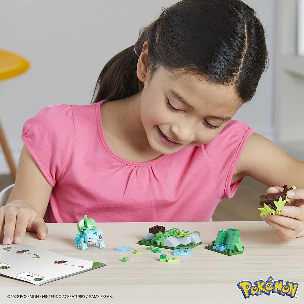 Girl building MEGA Pokémon Bulbasaur's Forest Trek 82 Piece Building Set