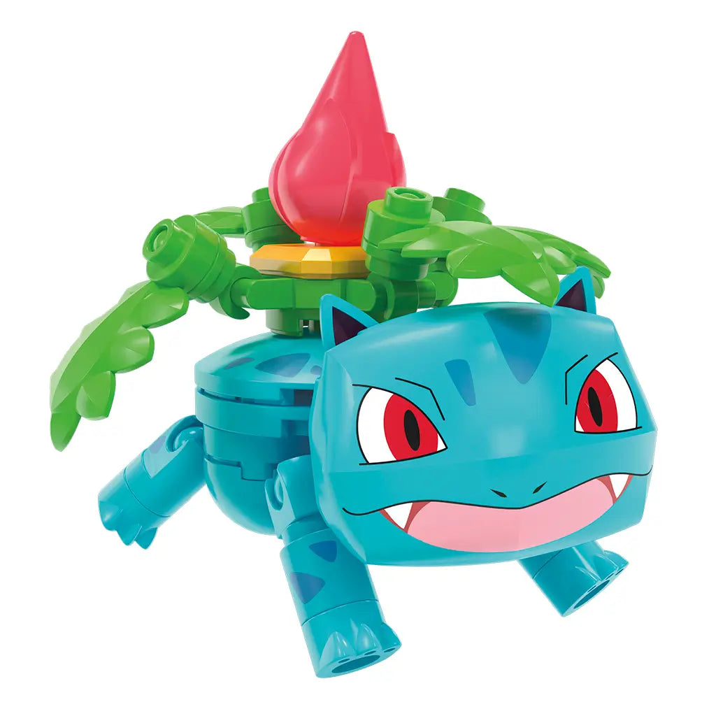 Pokémon Mega Construx Ivysaur figure features bright teal plastic body with red eyes and a blooming red bud on its back, built from interlocking bricks for play or display.