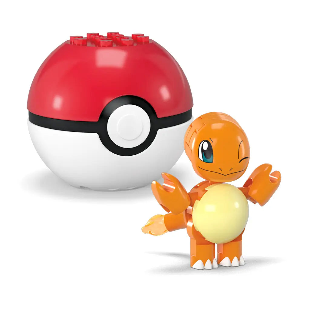 Mega Pokémon Charmander toy figure built from plastic blocks, posed smiling with one eye closed, displayed next to large red and white Poké Ball case with visible stud connectors on top.