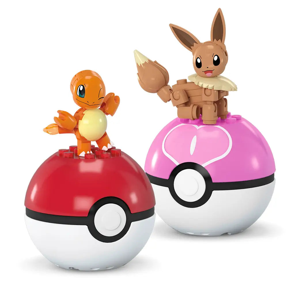 Mega Pokémon Charmander and Eevee toy figures shown perched on top of matching Poké Ball cases, one red and one pink, highlighting display compatibility and playful collectible design.