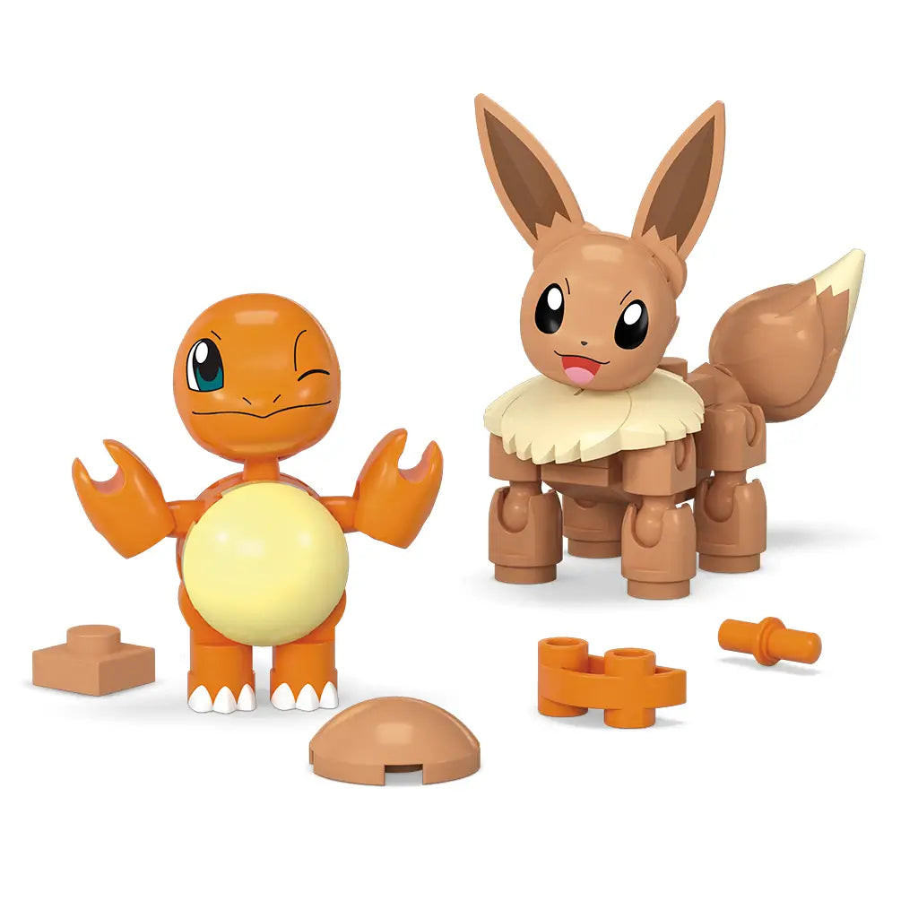 Mega Pokémon Charmander and Eevee building set with small plastic pieces shown on white background, featuring orange Charmander and brown Eevee figures alongside spare block parts.