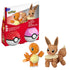 Retail package of Mega Pokémon Charmander and Eevee building set, showing boxed figures, two Poké Ball cases, branding logos, bilingual warning labels, and assembled toy figures in front.