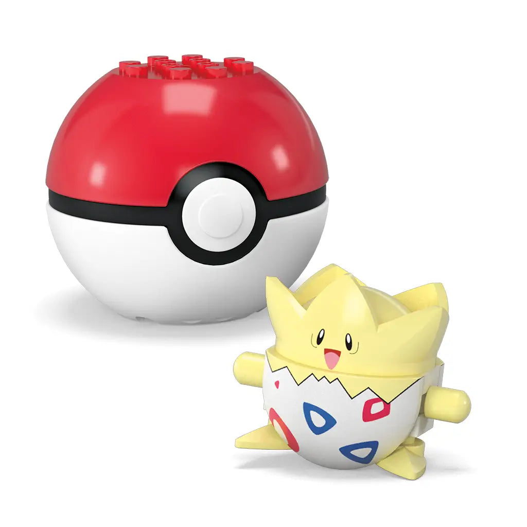 Mega Pokémon toy featuring Togepi, a round yellow and white egg-like character with red and blue designs, displayed beside a red Poké Ball with top brick studs on a plain white surface.