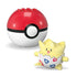 Mega Pokémon toy featuring Togepi, a round yellow and white egg-like character with red and blue designs, displayed beside a red Poké Ball with top brick studs on a plain white surface.