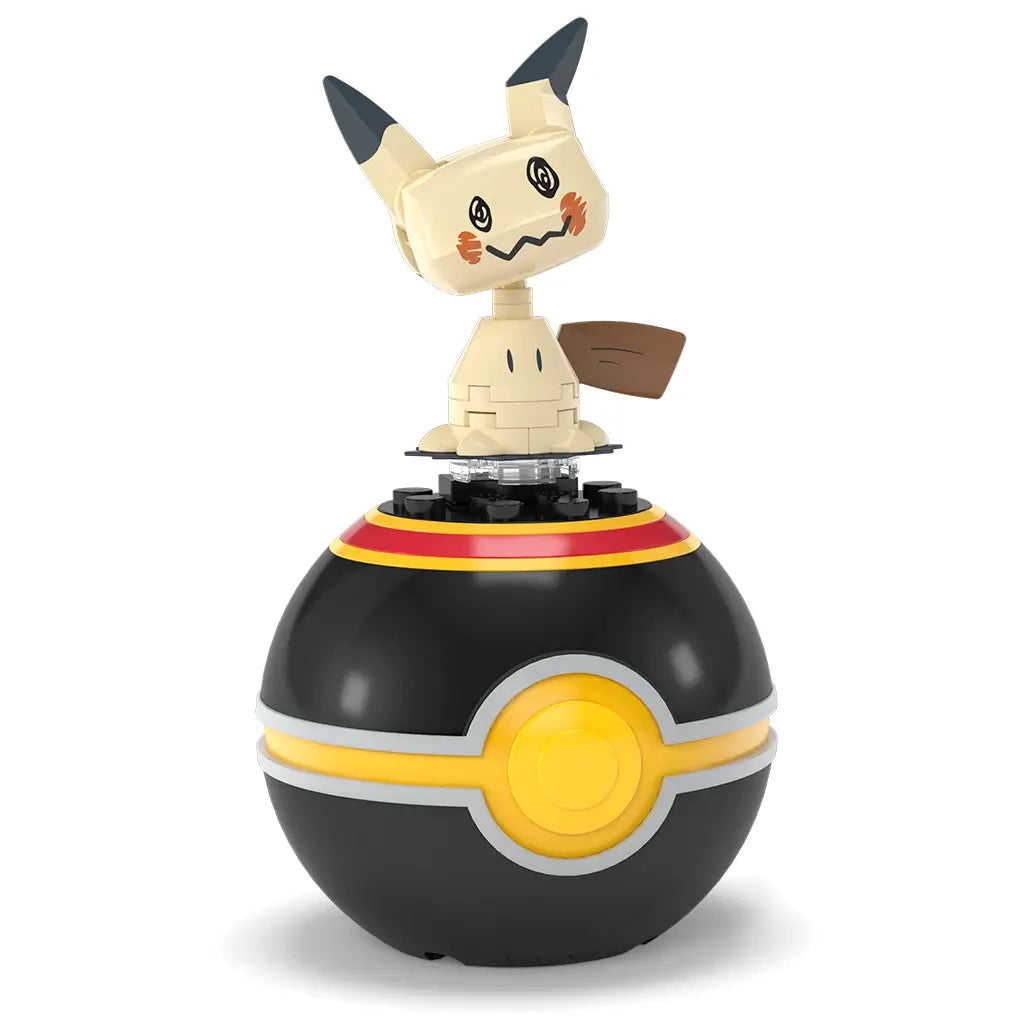 Mega Pokémon Mimikyu figure standing on top of a black Poké Ball with yellow center, posed on a clear base for display. This collector-friendly Mega Construx toy is ideal for fans ages six and older,