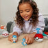 Young girl smiling and playing with MEGA Pokémon Water-Type Trainer Team figures, including Squirtle, Quaxly, Wooper, and Magikarp, each displayed with their respective Poké Balls.
