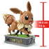Brown Mega Pokémon Eevee building set model measuring 18.3 cm or 7.2 inches tall, standing on a gray floral-patterned display base with visible gears.