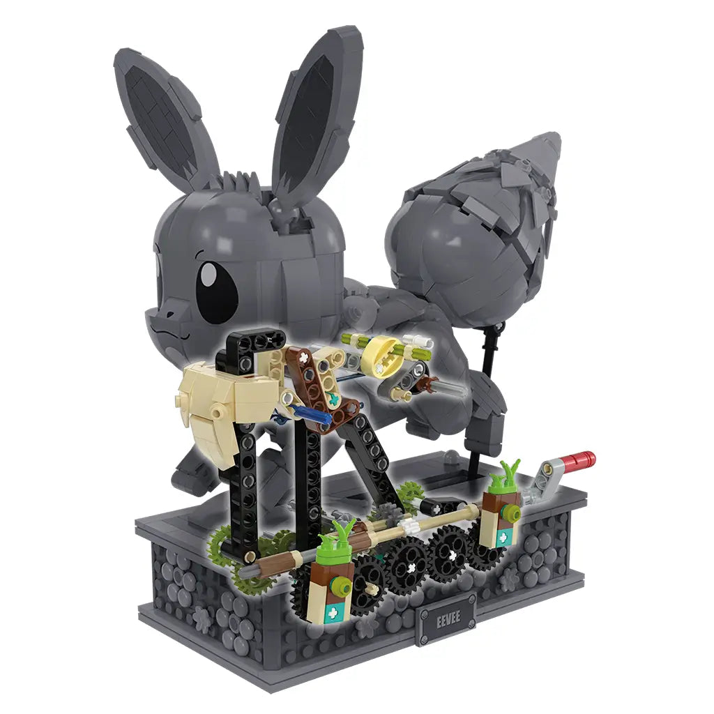 Gray plastic Mega Pokémon Eevee building set in mid-assembly, showing gears, rods, and internal motion mechanism on a gray floral-patterned display base.
