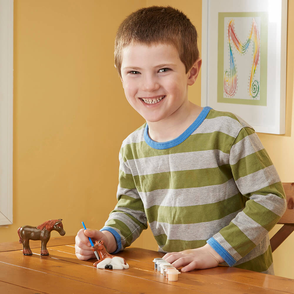 Boy painting a horse from Melissa and Doug Created by Me! Horse Figurines Craft Kit