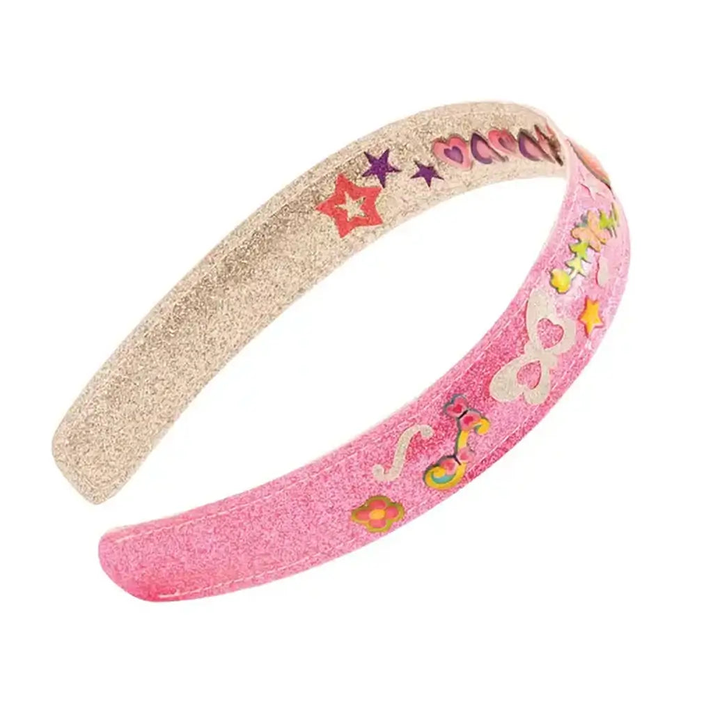 Melissa & Doug reversible glitter headband shown in close-up, featuring pink and silver foam surfaces with a smooth curved shape, decorated with heart, star, and flower stickers for customizable kids’ fashion play.