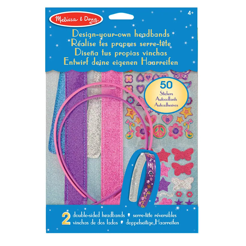 Melissa & Doug design-your-own headbands kit featuring bright pink plastic bands, glittery foam strips, and colorful adhesive stickers for kids’ craft play, shown neatly arranged inside retail packaging.