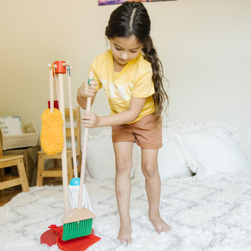 Girl cleaning with Melissa and Doug Dust, Sweep & Mop Play Set
