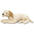 Melissa & Doug lifelike plush yellow Labrador puppy toy in cream fabric with golden brown ears, soft texture, and realistic details, shown lying down as a cuddly companion for kids.