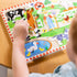 Child holding a wooden animal piece from Melissa & Doug Old MacDonald’s Farm sound puzzle, exploring texture and shape for early fine motor development and tactile learning experience.