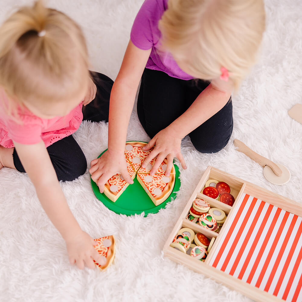 Two kids playing with the Melissa and Doug Pizza Party Wooden Food Play Set