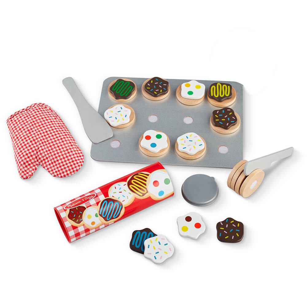 The Melissa and Doug Slice and Bake Cookie Wooden Food Play Set includes bake tray, cookies, cooking tools, pretend cookie dough, oven mitt, and more.