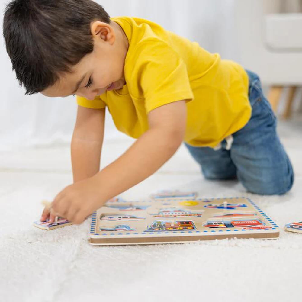 Image of a younger boy playing Melissa and Doug Vehicles 8 Piece Sound Puzzle