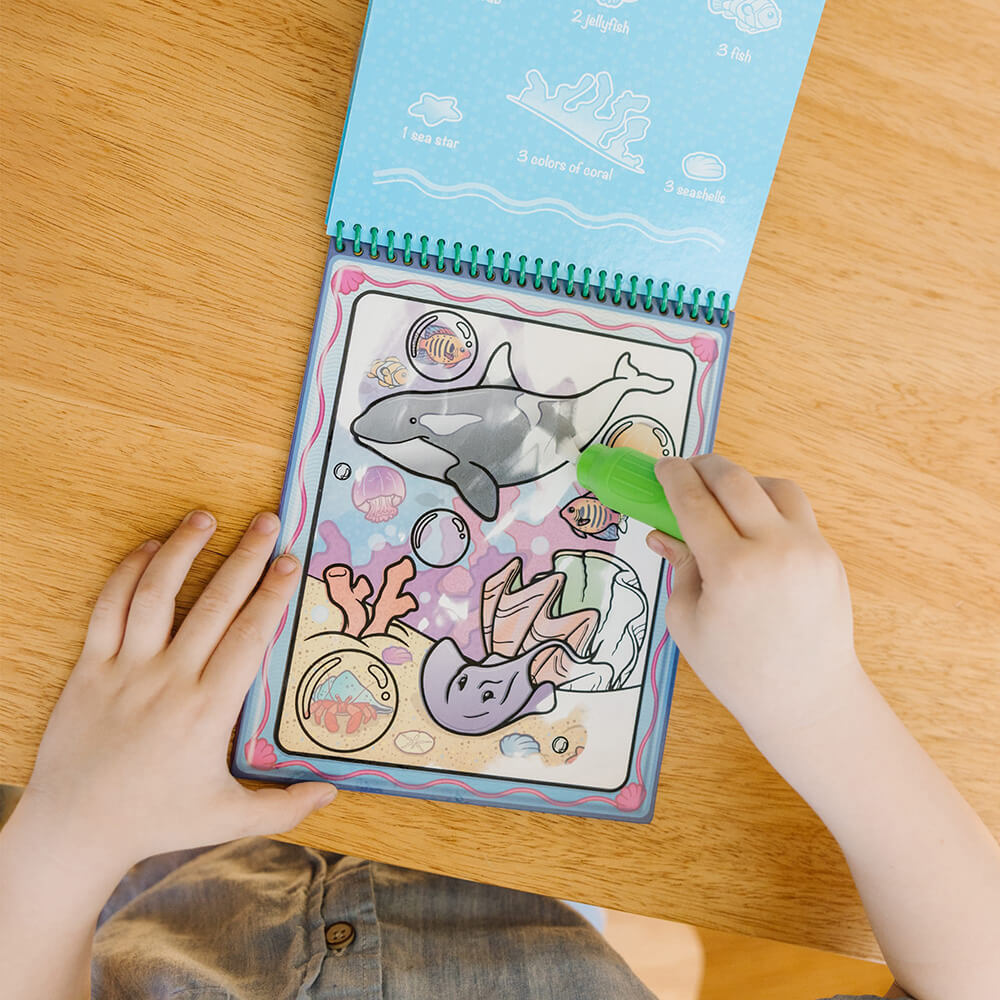 Child coloring page with pen filled with water of the Melissa and Doug Water Wow! Animals Water-Reveal On the Go Travel Activity Pad
