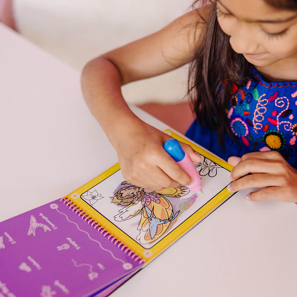 Girl coloring with water in her Melissa and Doug Water Wow! Fairy Tale Water-Reveal On the Go Travel Activity Pad