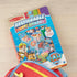 Paw Patrol puffy sticker set partially tucked into a red and yellow backpack, showing Melissa & Doug packaging with bright characters and reusable stickers for imaginative play.