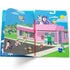 Open Paw Patrol puffy sticker book with characters placed on a bright pet shop scene, featuring a pink building, green grass, and blue skies with a cheerful cartoon shopkeeper.
