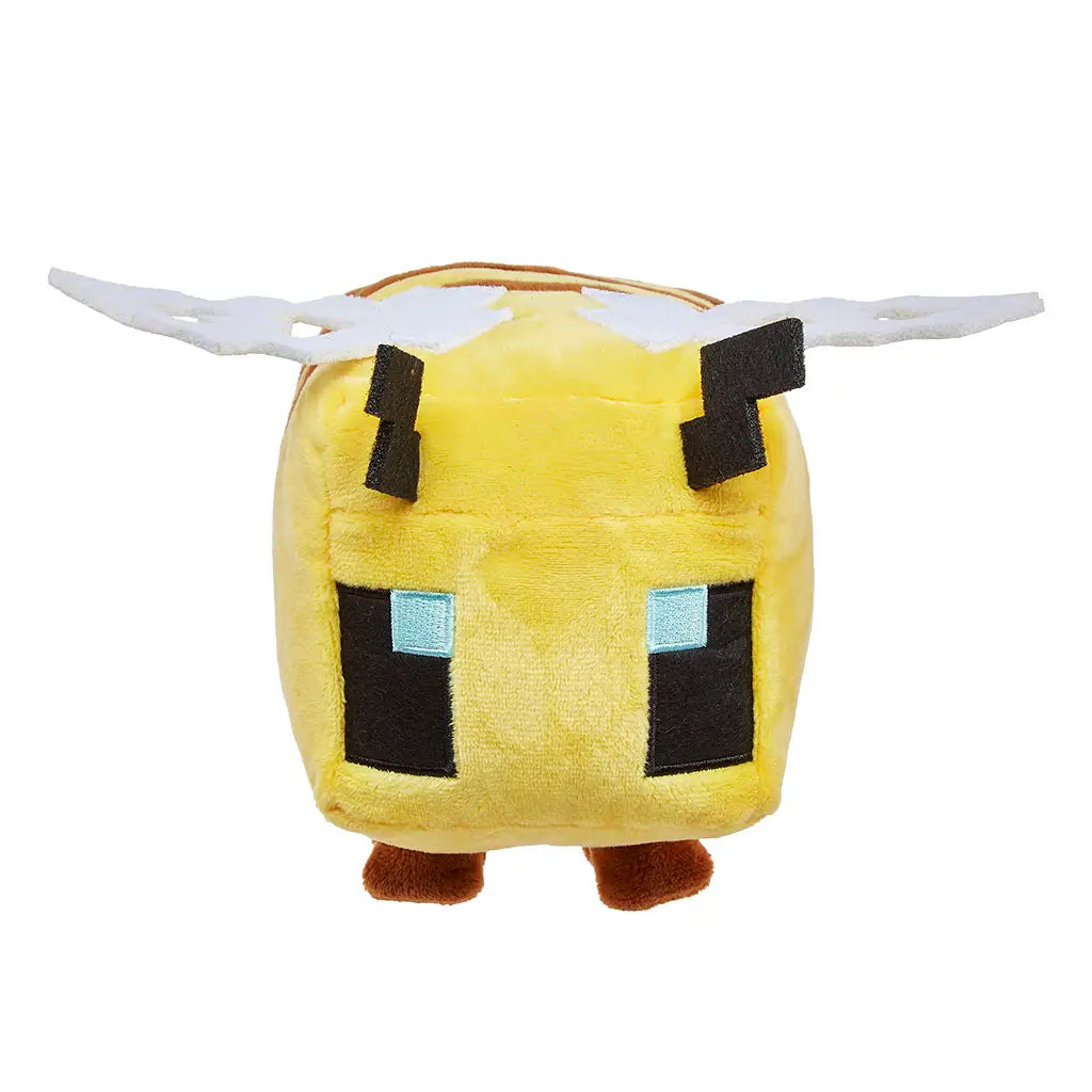 Minecraft bee plush front view displaying a yellow soft-textured cube body, symmetrical pixel eyes with blue highlights, white felt wings extending outward, and small plush legs, presented as an 8-inch character toy on white.
