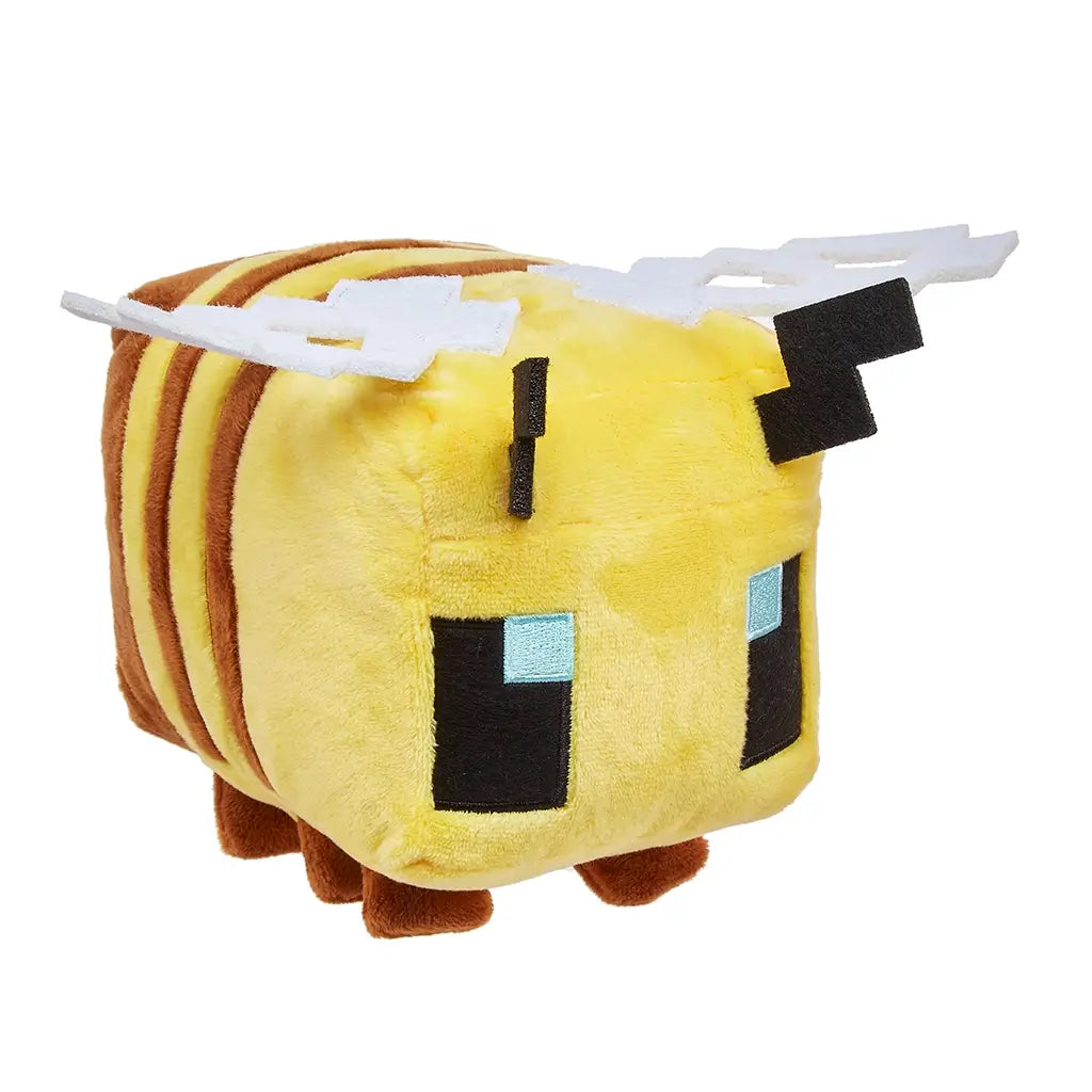 Minecraft bee plush toy in bright yellow and brown soft fabric with a blocky cube shape, pixel-style blue eyes, white felt wings, and short legs, designed as an 8-inch collectible inspired by the game, shown on a clean white background.