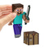 Hand holding Minecraft Steve action figure with pixelated design, posed with iron sword and crafting table accessory for play.