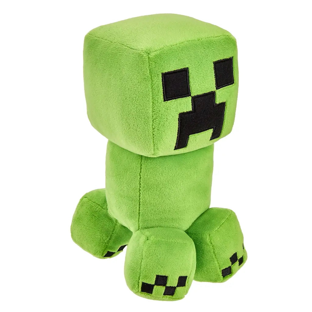 Green Minecraft Creeper plush figure with smooth fuzzy fabric, square head and tall rectangular body, embroidered black pixel eyes and mouth, compact legs, shown from a slightly rotated angled view.