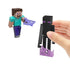 Hand holding Minecraft Enderman figure beside Steve with pixelated weapon, part of the 3.25-inch Enderman Encounter action figure playset.