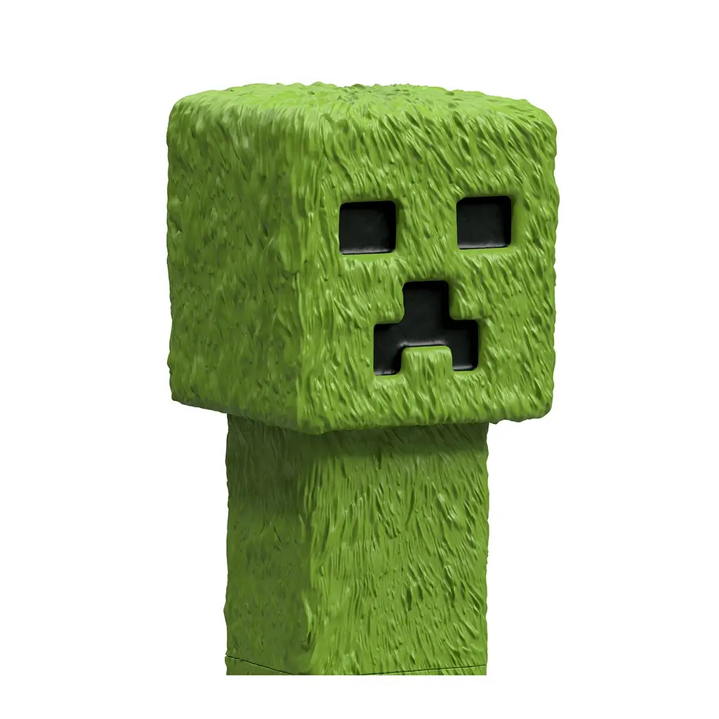 Detailed closeup of Minecraft Creeper toy showing green textured blocky surface, square head, and iconic pixelated black eyes and mouth from the popular video game.