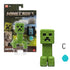 Minecraft Creeper action figure by Mattel in retail packaging, featuring green textured plastic, square head, pixelated face, and accessories against a blocky landscape backdrop.