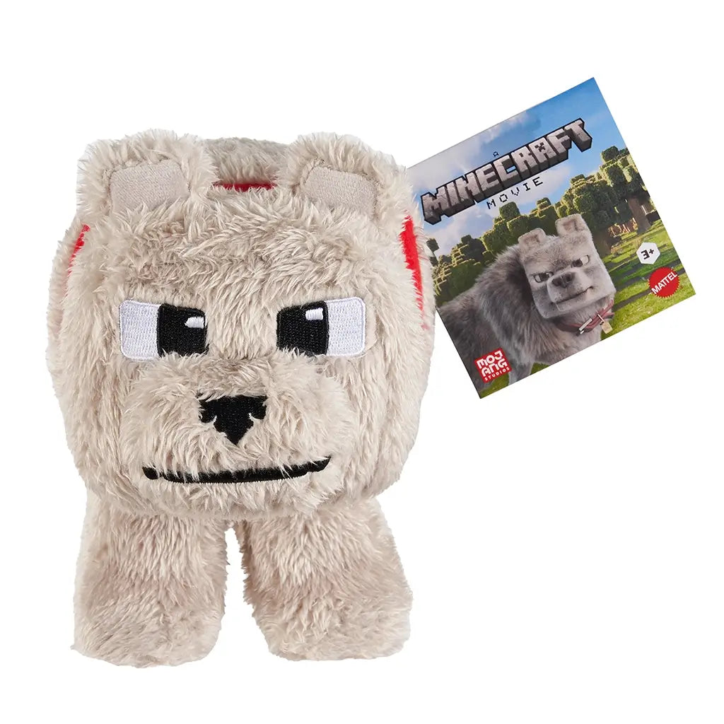 Minecraft plush toy of Dennis the wolf from the Minecraft Movie, made of soft beige fabric with blocky shape, embroidered black-and-white eyes, red collar, and branded hang tag.