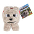 Minecraft plush toy of Dennis the wolf from the Minecraft Movie, made of soft beige fabric with blocky shape, embroidered black-and-white eyes, red collar, and branded hang tag.