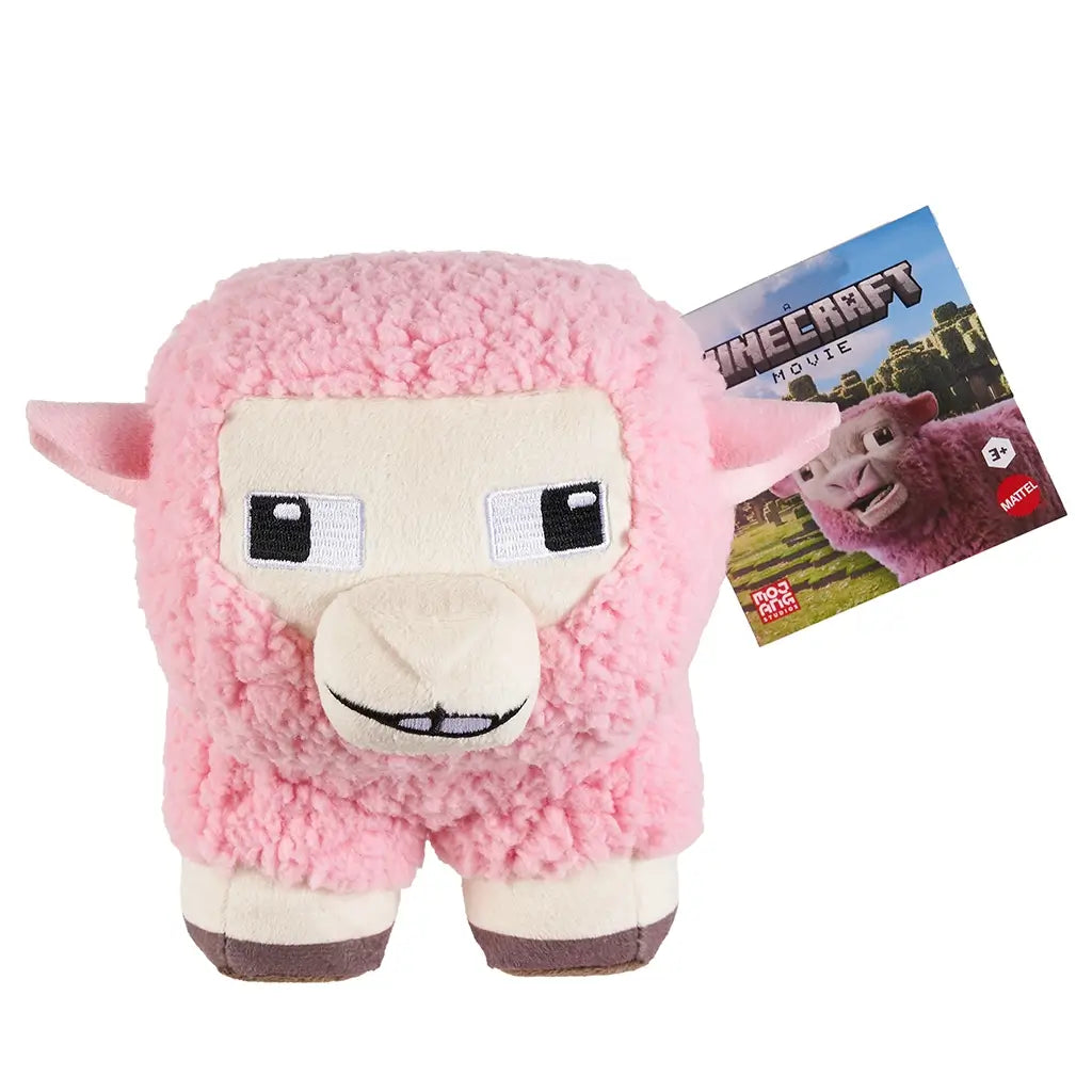 Minecraft Movie pink sheep plush toy, 8-inch size, featuring soft textured pink fleece, square pixel-inspired face, embroidered black and white eyes, and brown hooves with official tag attached.