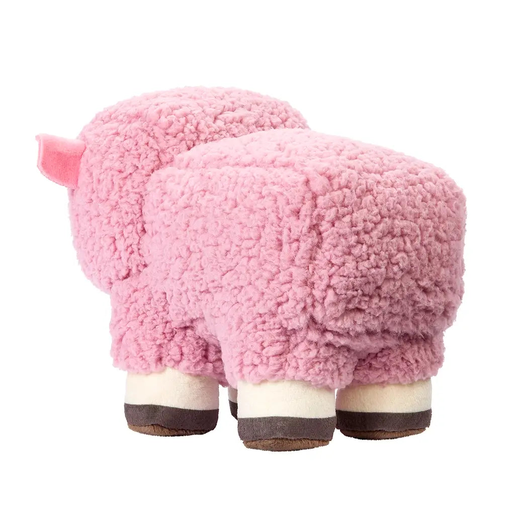 Rear angled view of Minecraft Movie pink sheep plush toy, highlighting soft curly pink fleece texture, squared blocky shape, and four cream and brown hooves resembling the in-game pixelated sheep.