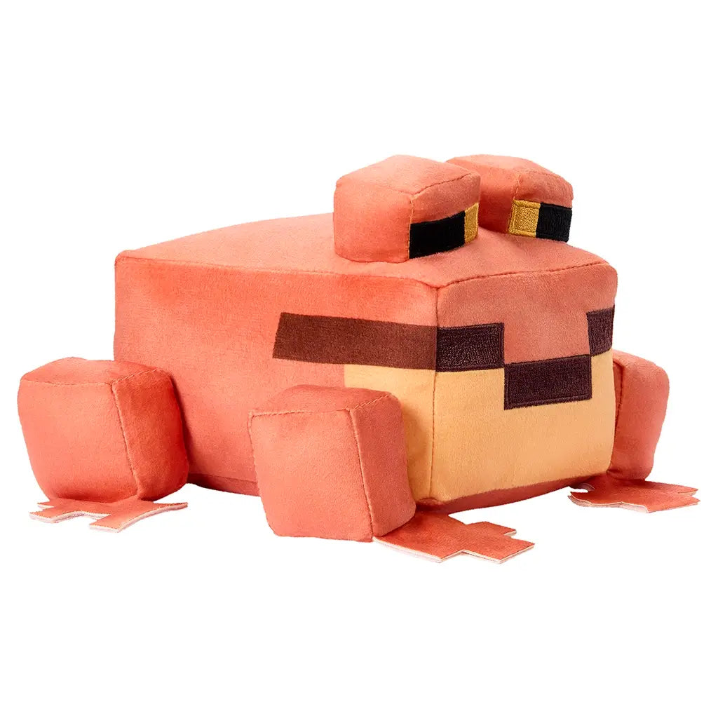 Minecraft orange frog plush in orange and tan tones, smooth velvety polyester texture, cubic body with short block legs, shown from a left angled view to highlight shape and stitching on a white background.