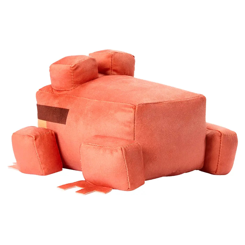 Minecraft orange frog plush toy showing orange fabric and block-style construction, soft plush texture, square body and raised eyes, rear angled view emphasizing seams and form against a clean white background.