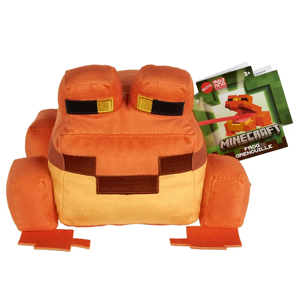 Minecraft orange frog plush doll in orange and tan colors, soft plush polyester fabric, blocky frog form with raised square eyes, shown with branded hang tag for retail identification on a white background.
