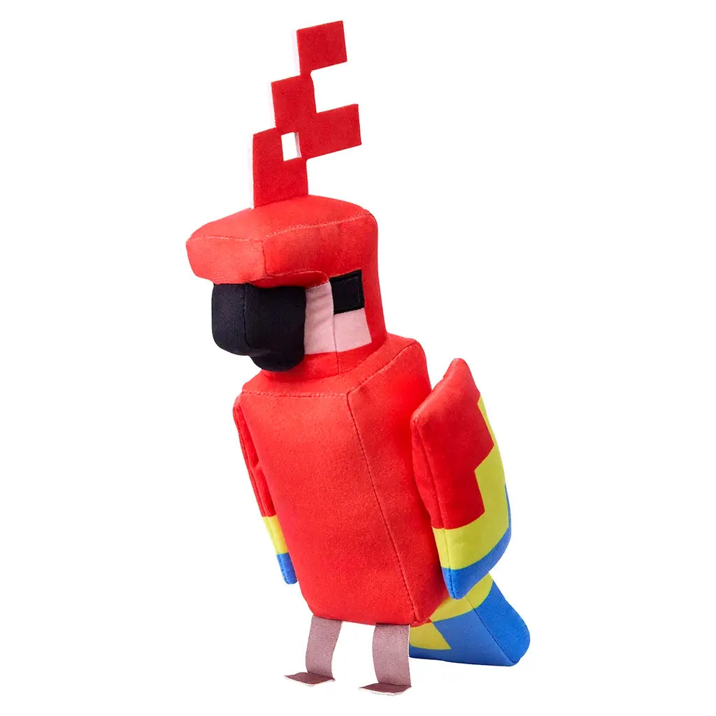 Minecraft parrot plush toy in vivid red soft fabric with blocky rectangular shape, bright yellow and blue wing panels, black square beak and eyes, standing upright as an 8-inch collectible character on a clean white background.