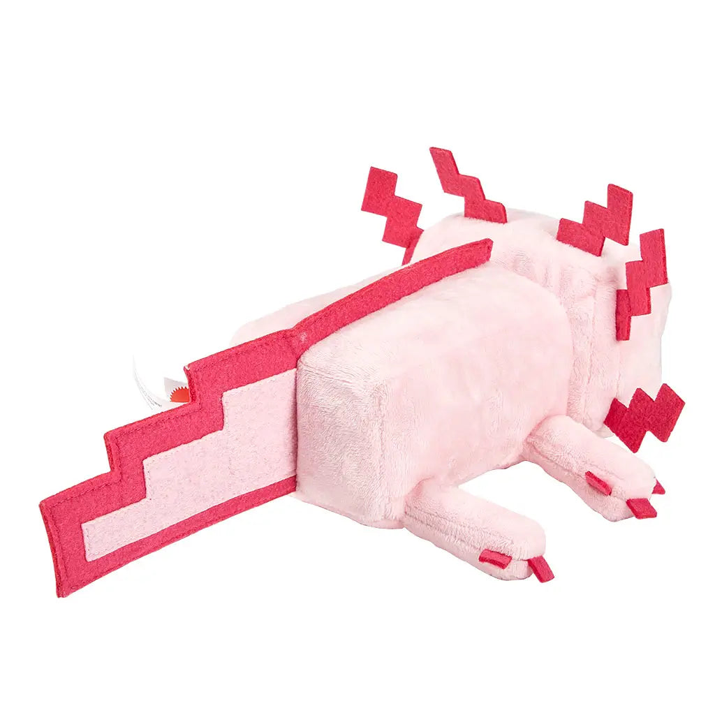 Minecraft pink axolotl plush rear angled view displaying a soft light pink block-form body, flat tail with stepped pixel edges, short plush legs, and red felt gill details along the head, presented as an 8-inch character toy on white.