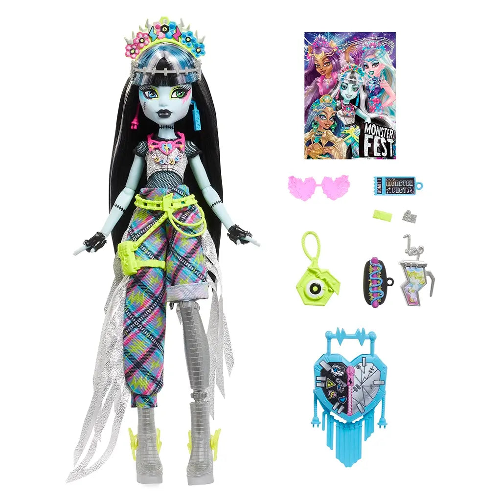 Monster High Frankie Stein doll with removable accessories including blue heart-shaped bag, neon camera, pink glasses, drink cup, wristbands, and colorful event poster.