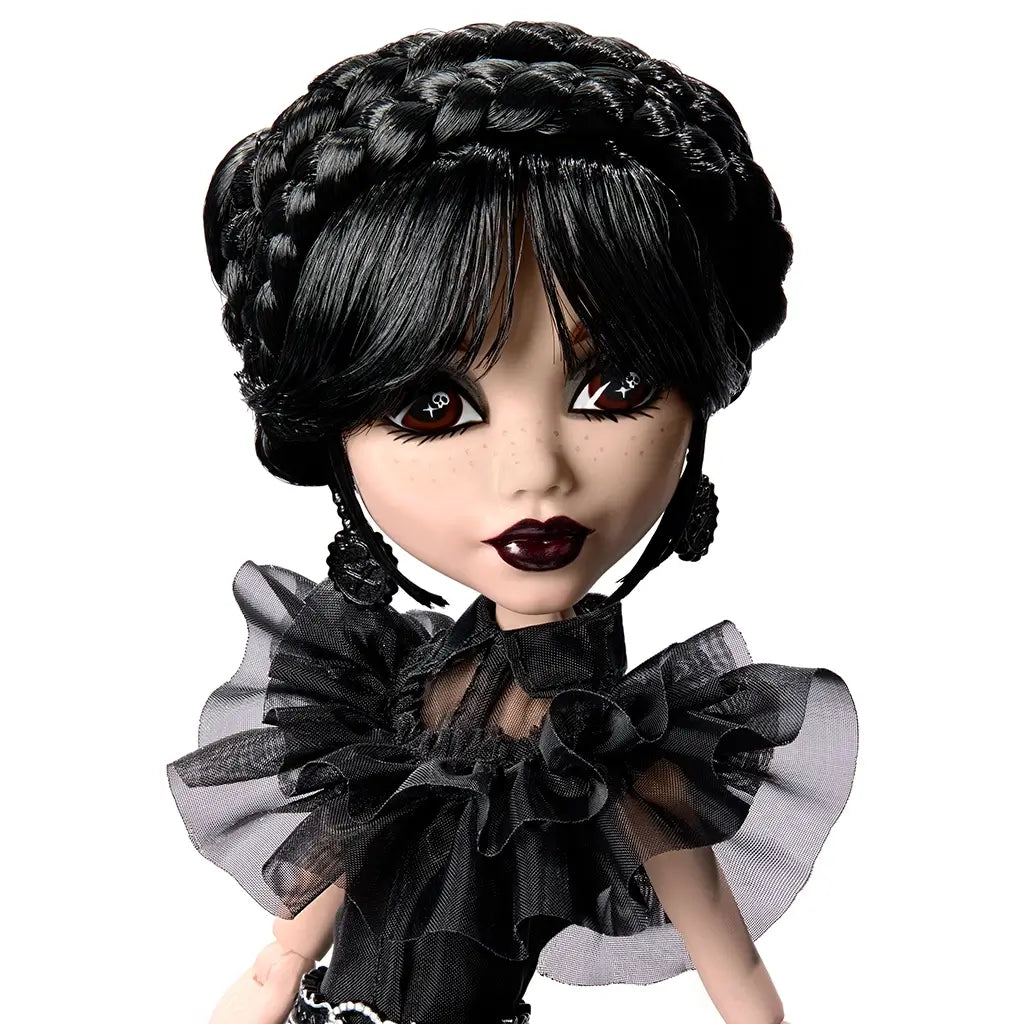 Monster High Rave N’ Wednesday fashion doll with black braided updo, gothic makeup, ruffled sheer black top, and skull-accent earrings, showcasing her spooky-chic aesthetic.