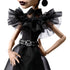 Close-up of Monster High Rave N’ Wednesday doll’s fitted black dress with layered sheer ruffles, high neckline, and silver skull belt detail, highlighting gothic-inspired fashion design.