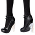 Monster High Rave N’ Wednesday doll wearing black high-heeled shoes with double straps, skull details, and translucent jagged crystal-style heels, paired with textured black tights.