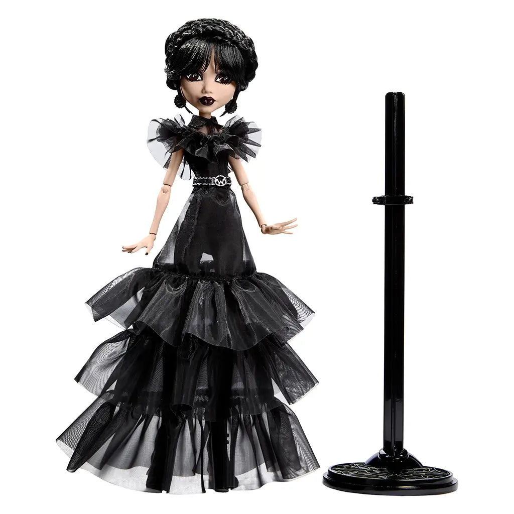 Full Monster High Rave N’ Wednesday doll in tiered black ruffled gown with silver skull belt, displayed beside a matching black doll stand for posing and display.