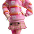 Close-up of Monster High Enid Sinclair doll outfit showing pink heart-print sweater, plaid pink skirt with button accents, and multicolor manicured nails for stylish detailing.